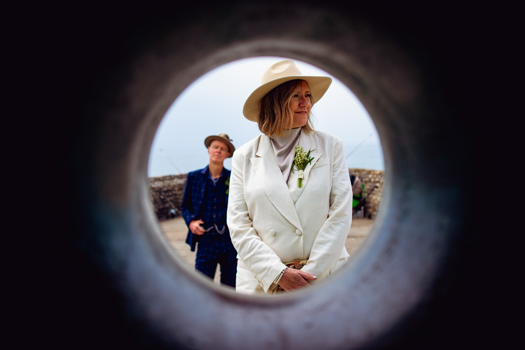 A shot through the centre of the Brighton donut statue of Mary and Mike during a couple portrait session.