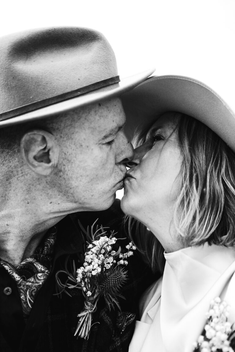 Mary and Mike kiss during a couple portrait at their Brighton wedding.