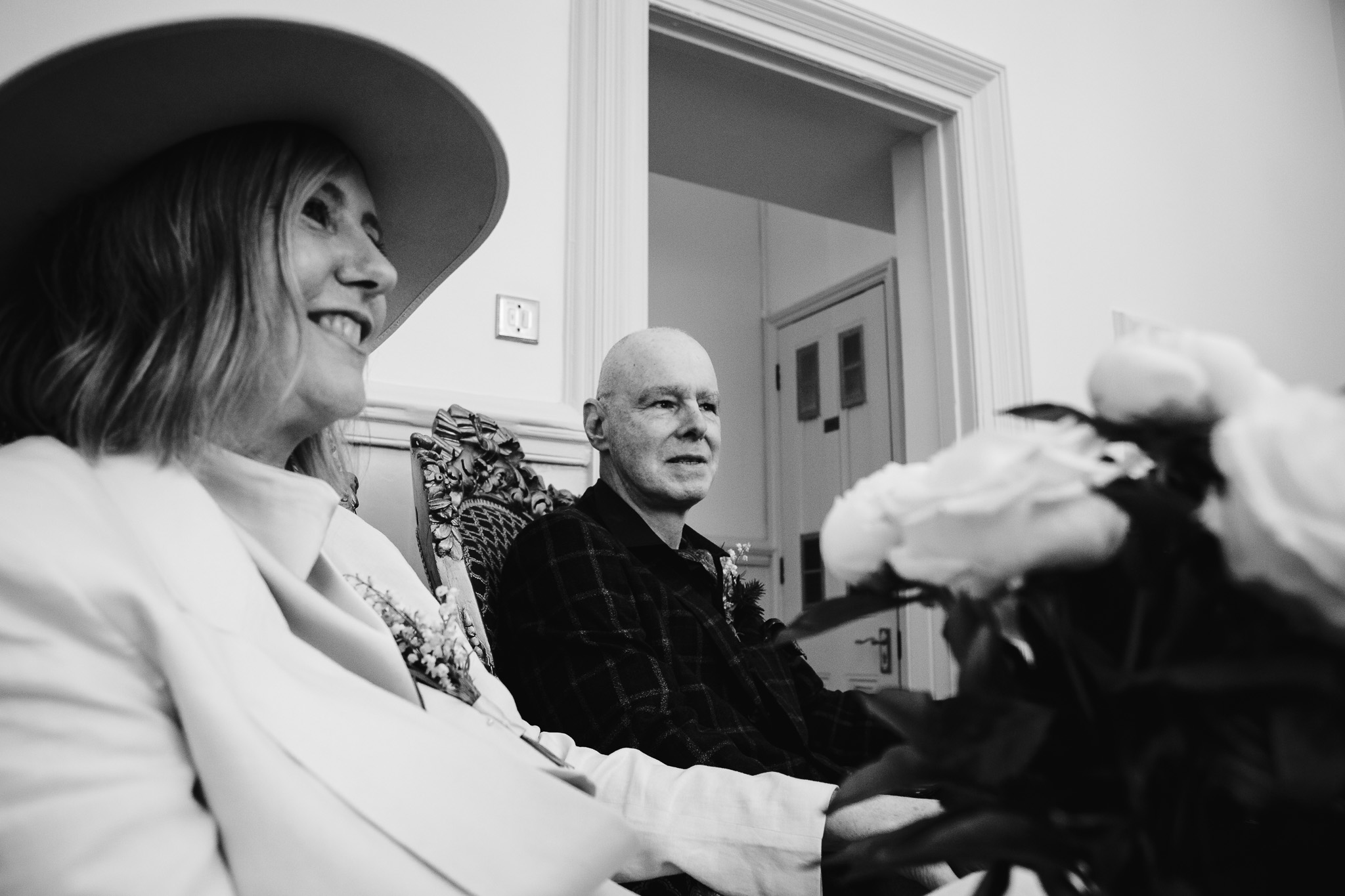 Mary and Mike sit together in a back room of Brighton Town Hall waiting for their wedding ceremony to start.