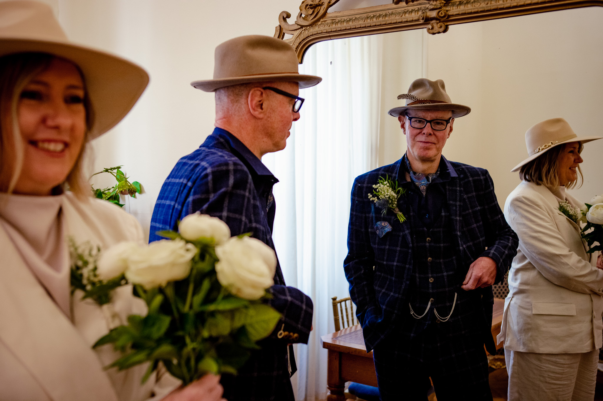 Mike looks into the mirror standing next to Mary waiting for their wedding ceremony to start at Brighton Town Hall.