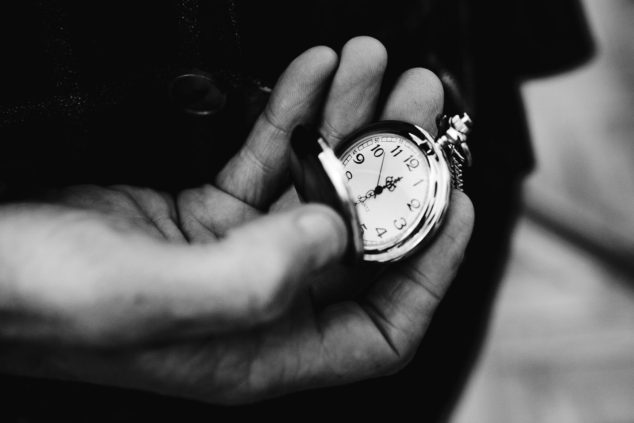 Close-up of a hand holding an old vintage pocket watch.