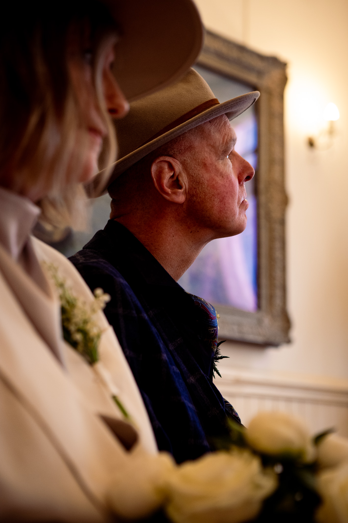 Side on portrait of Mike looking up during his wedding ceremony at Brighton Town Hall.