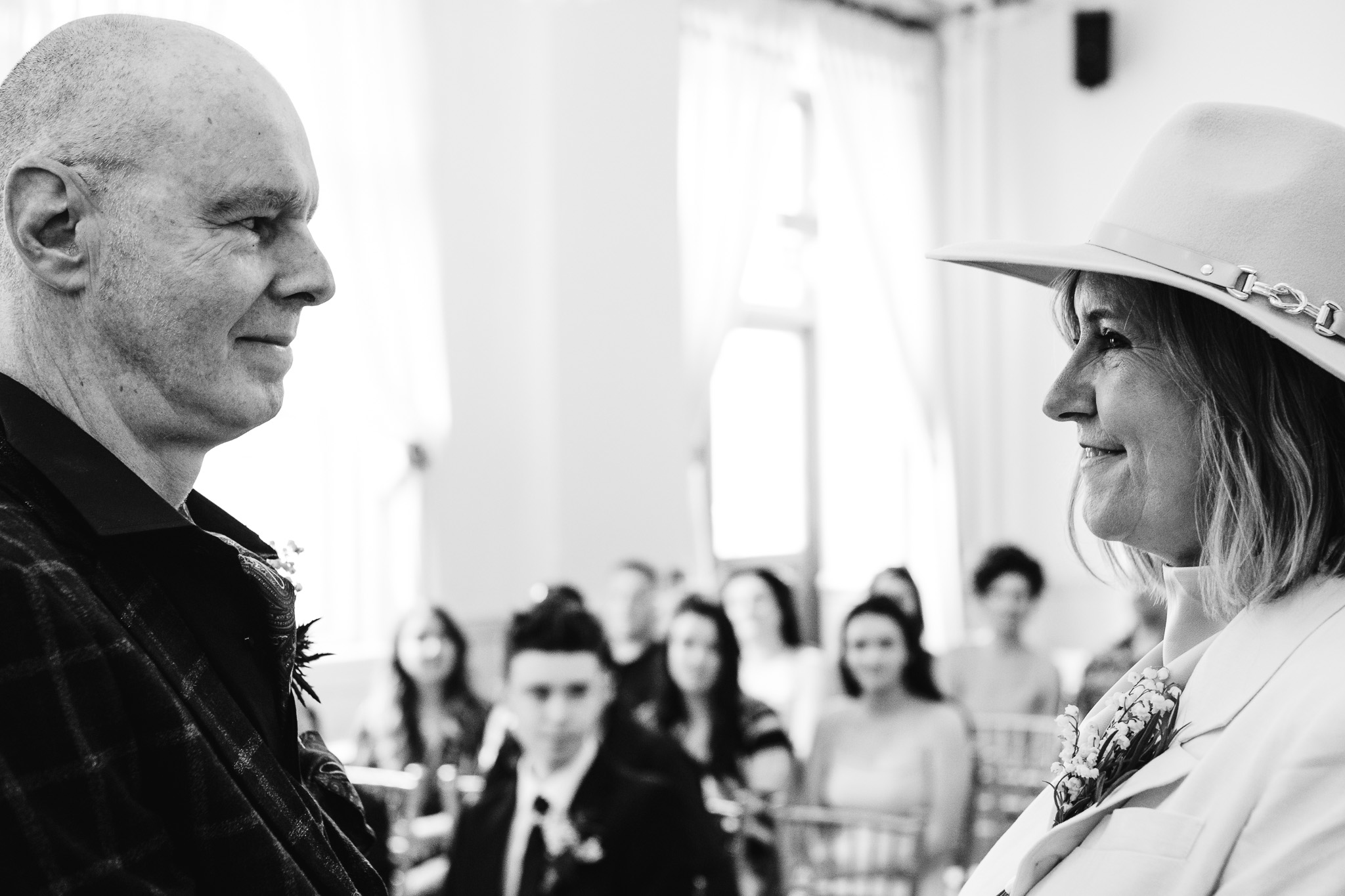 Mary and Mike smile at each other during their wedding ceremony at Brighton Town Hall.