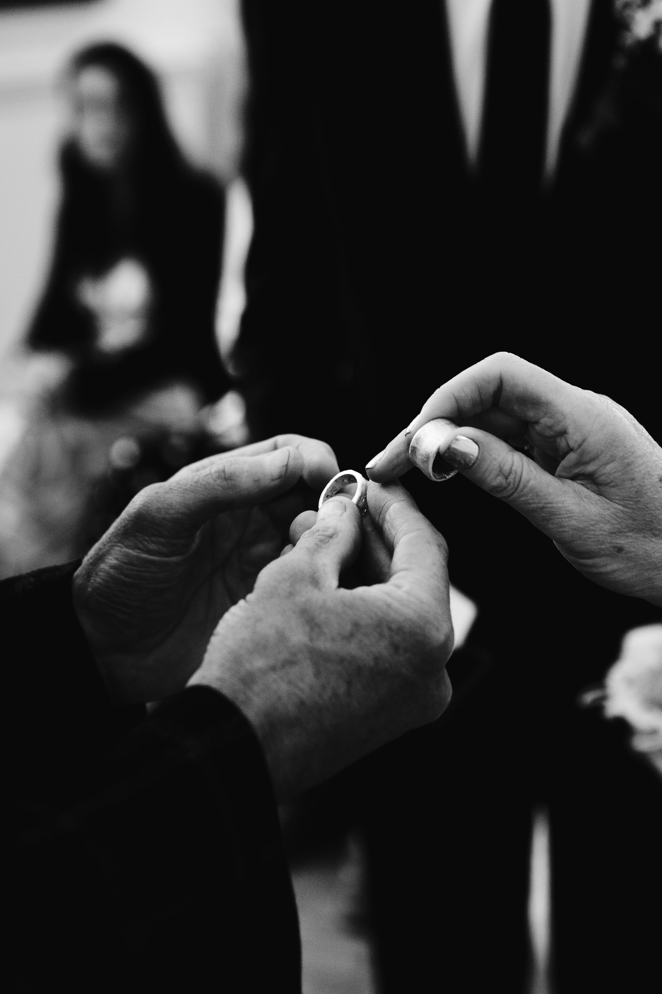 Close-up of the bride and groom exchanging their wedding rings during their wedding ceremony.