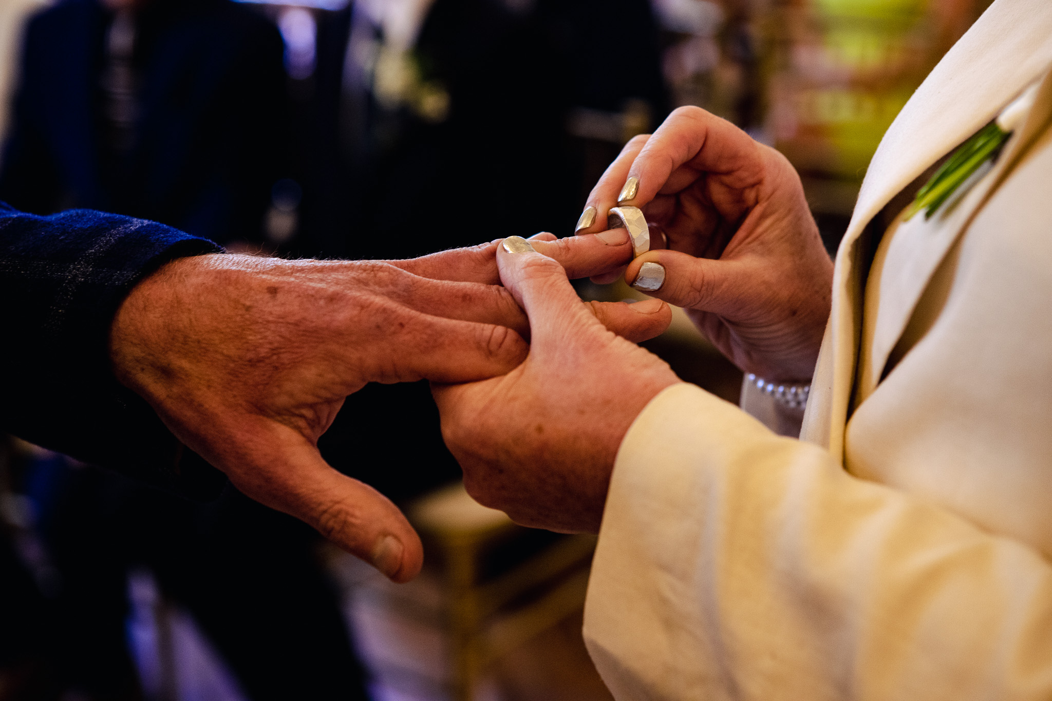 Bride putting on groom's wedding ring during their wedding ceremony at Brighton Town Hall.