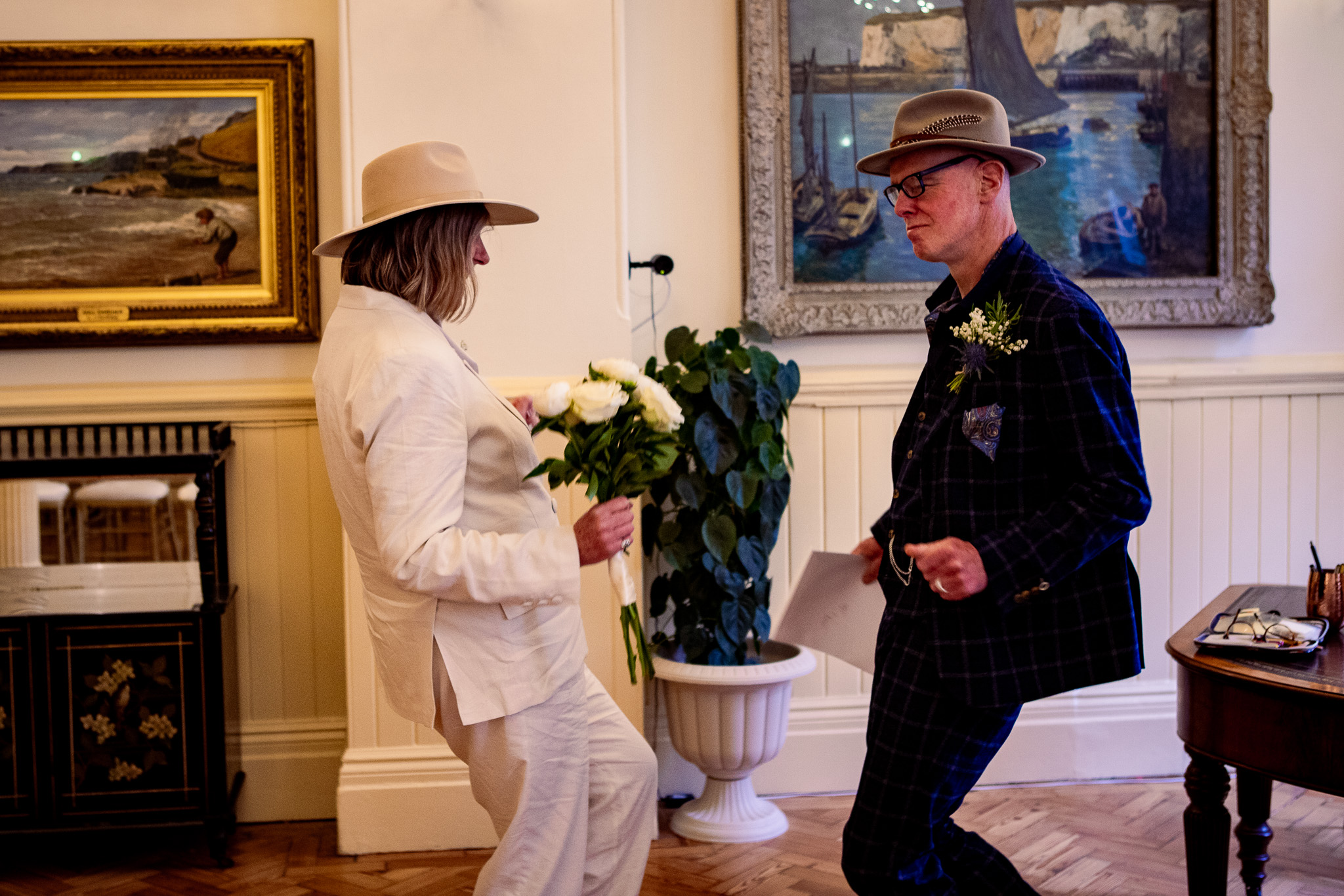Mary and Mike celebrate during their wedding ceremony with a little dance in Brighton Town Hall.