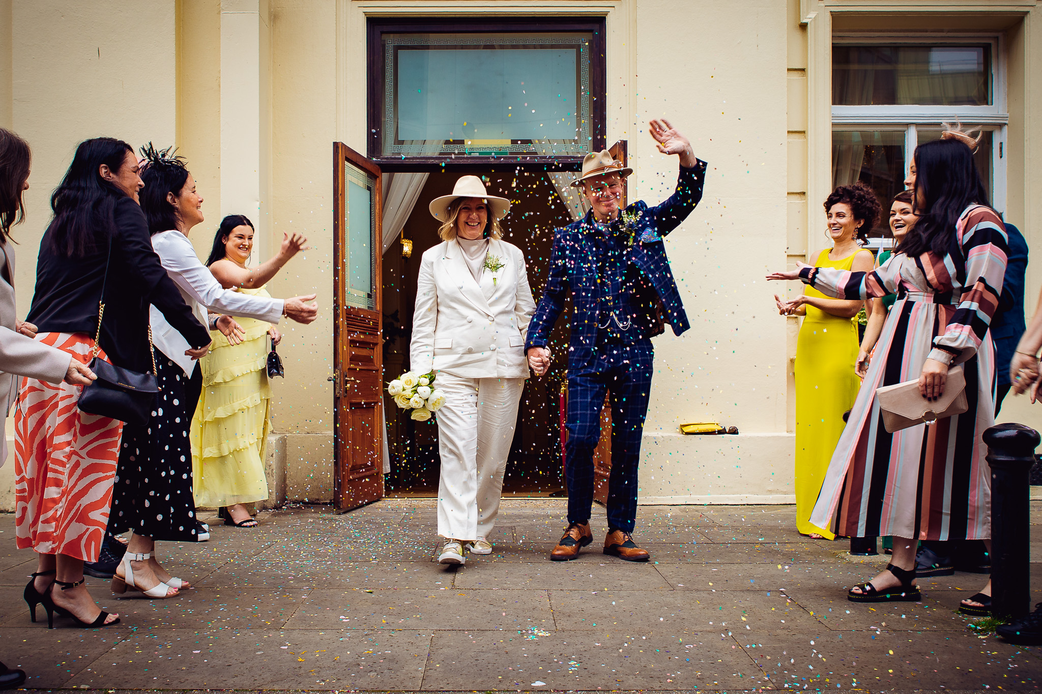 Mary and Mike walk through their guests as they throw confetti after their wedding ceremony at Brighton Town Hall.