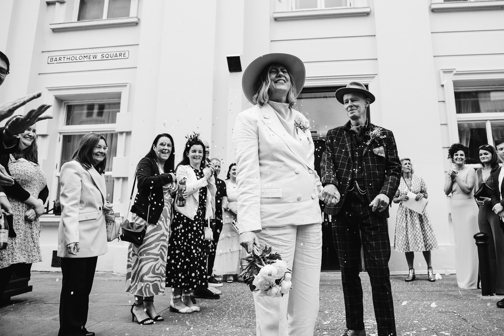 Mary and Mike smile as they have confetti thrown at them outside Brighton Town Hall.